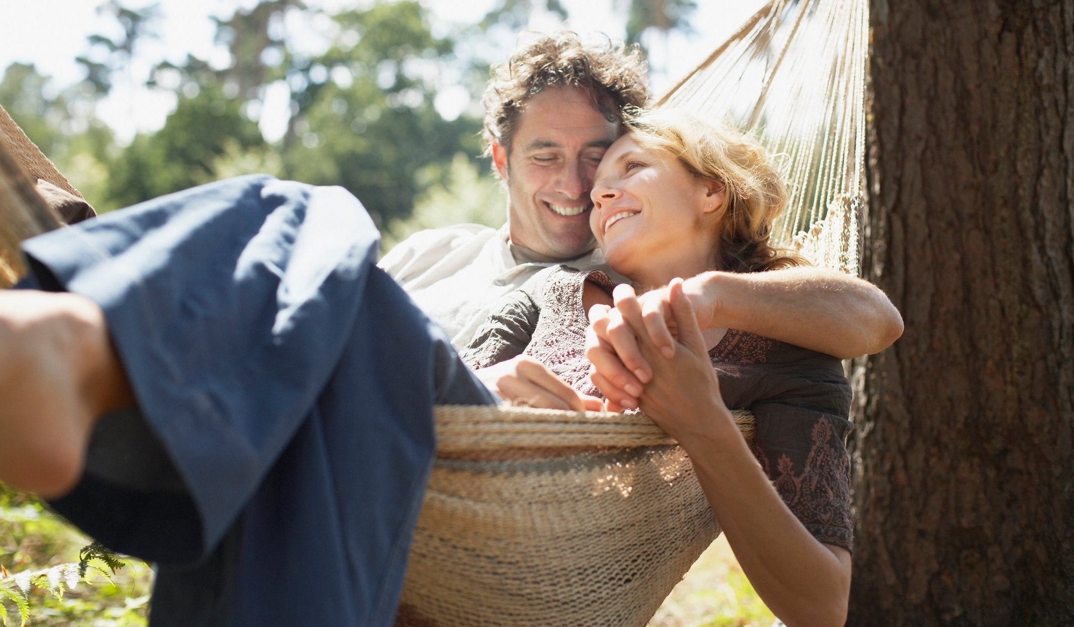 Man and woman in hammock smiling