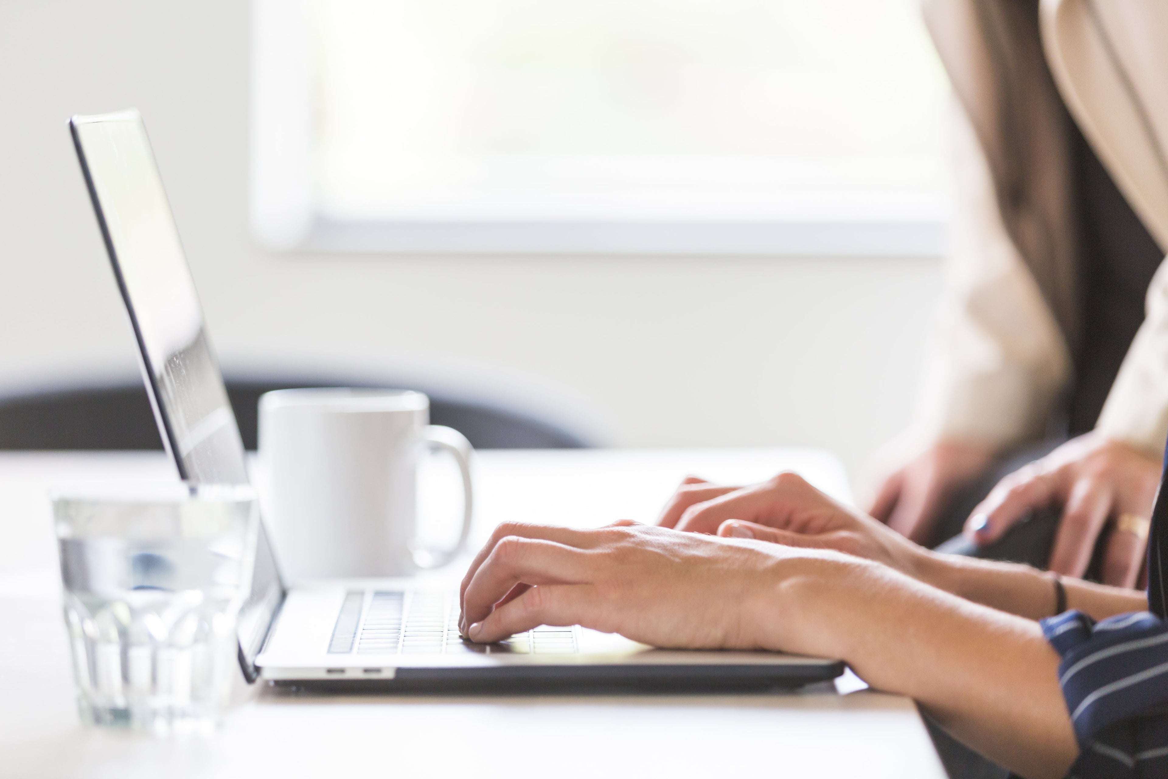 woman in office working on laptop
